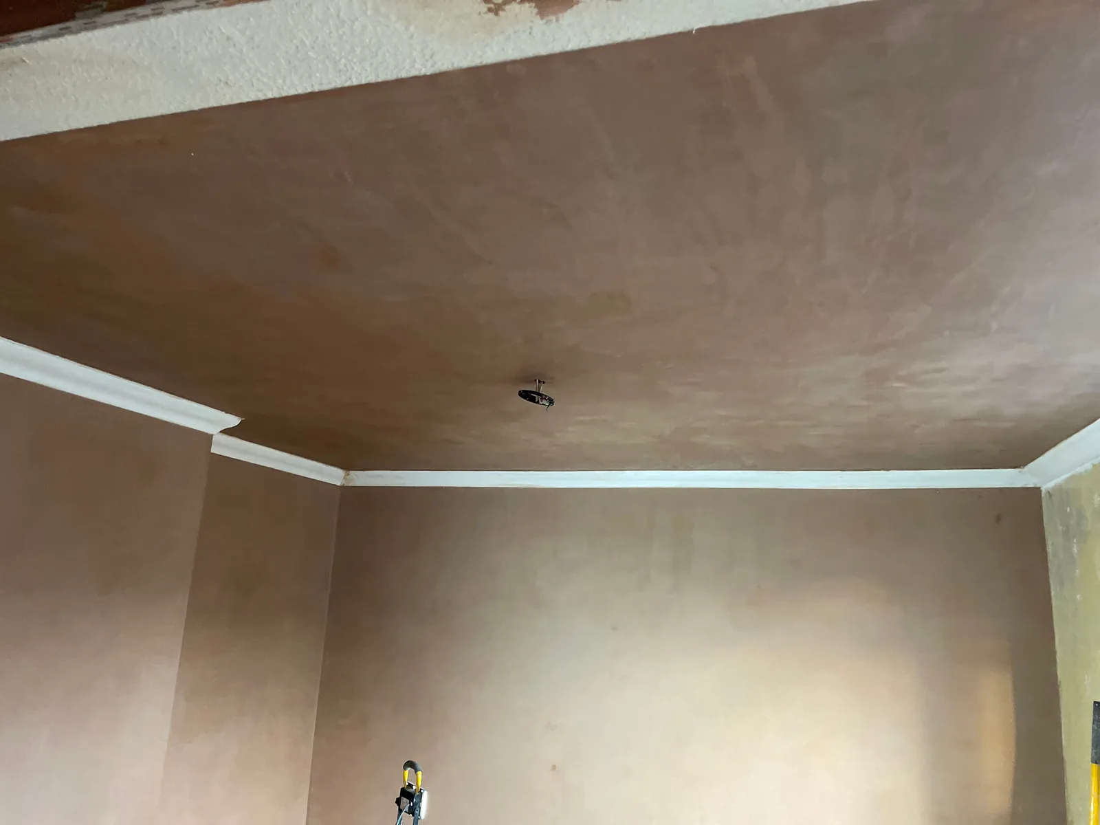 Smooth plaster finish on ceiling and wall corner